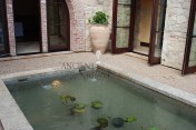 The legendary antique wall fountain, stone channel and coy pond combination, commissioned and realized by Ancient Surfaces, installed in Irvine California. Has been featured in many showcase home tours as well as on the front covers of national shelter magazines. www.AncientSurfaces.com