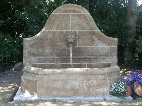 Antique lion head wall fountain by Ancient Surfaces.