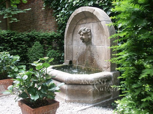 Antique Cherub head wall fountain by Ancient Surfaces.