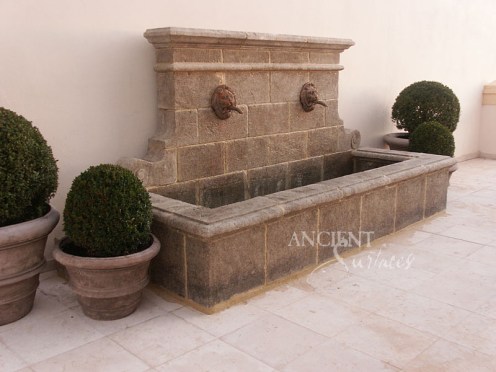 Antique double headed lion wall fountain by Ancient Surfaces.
