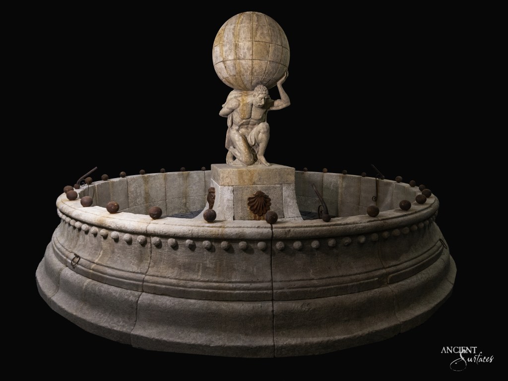 Vintage limestone fountain by Ancient Surfaces, featuring a statue of a man holding a sphere over his head, reminiscent of classic Greek sculpture.